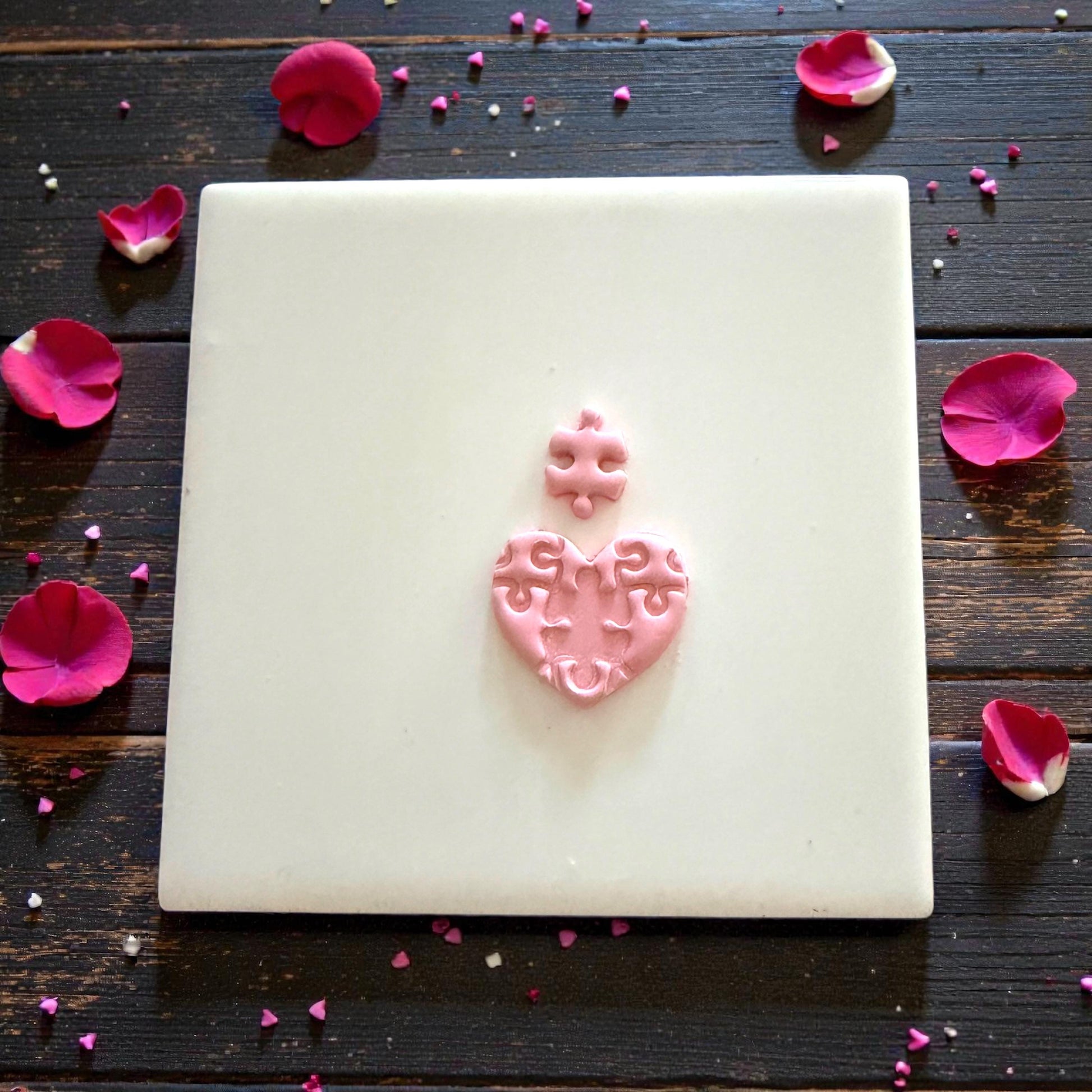 small puzzle heart impression centered on tile