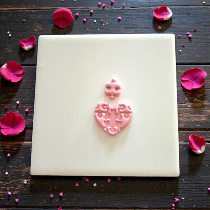 small puzzle heart impression centered on tile