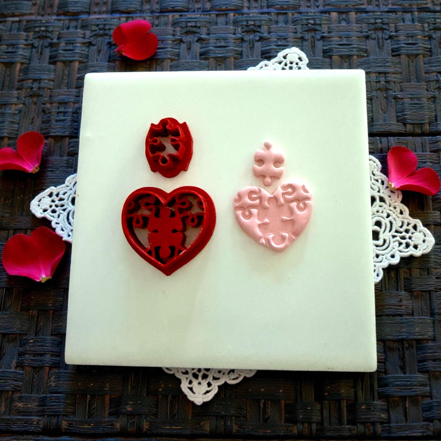 red puzzle heart cutter and pink clay impression