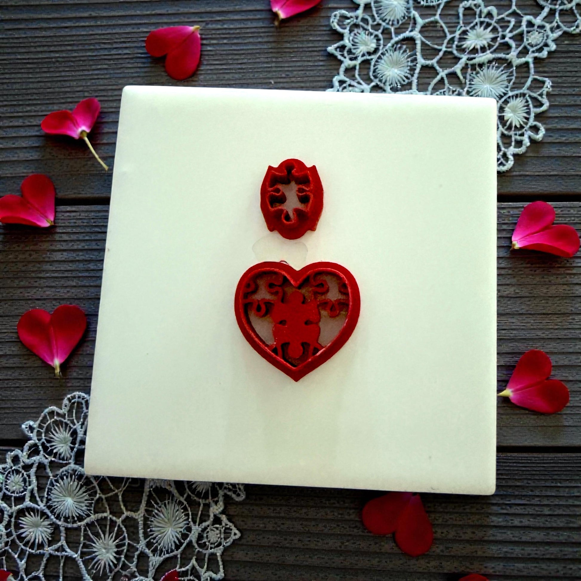 red cutter with puzzle heart stamp on lace