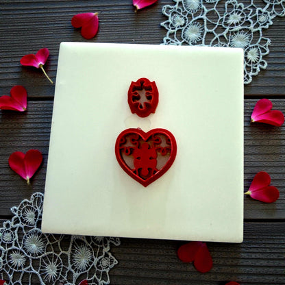 red cutter with puzzle heart stamp on lace