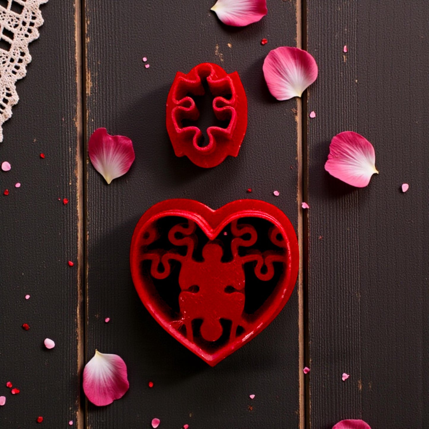 close up of red cutter with puzzle heart stamp on lace