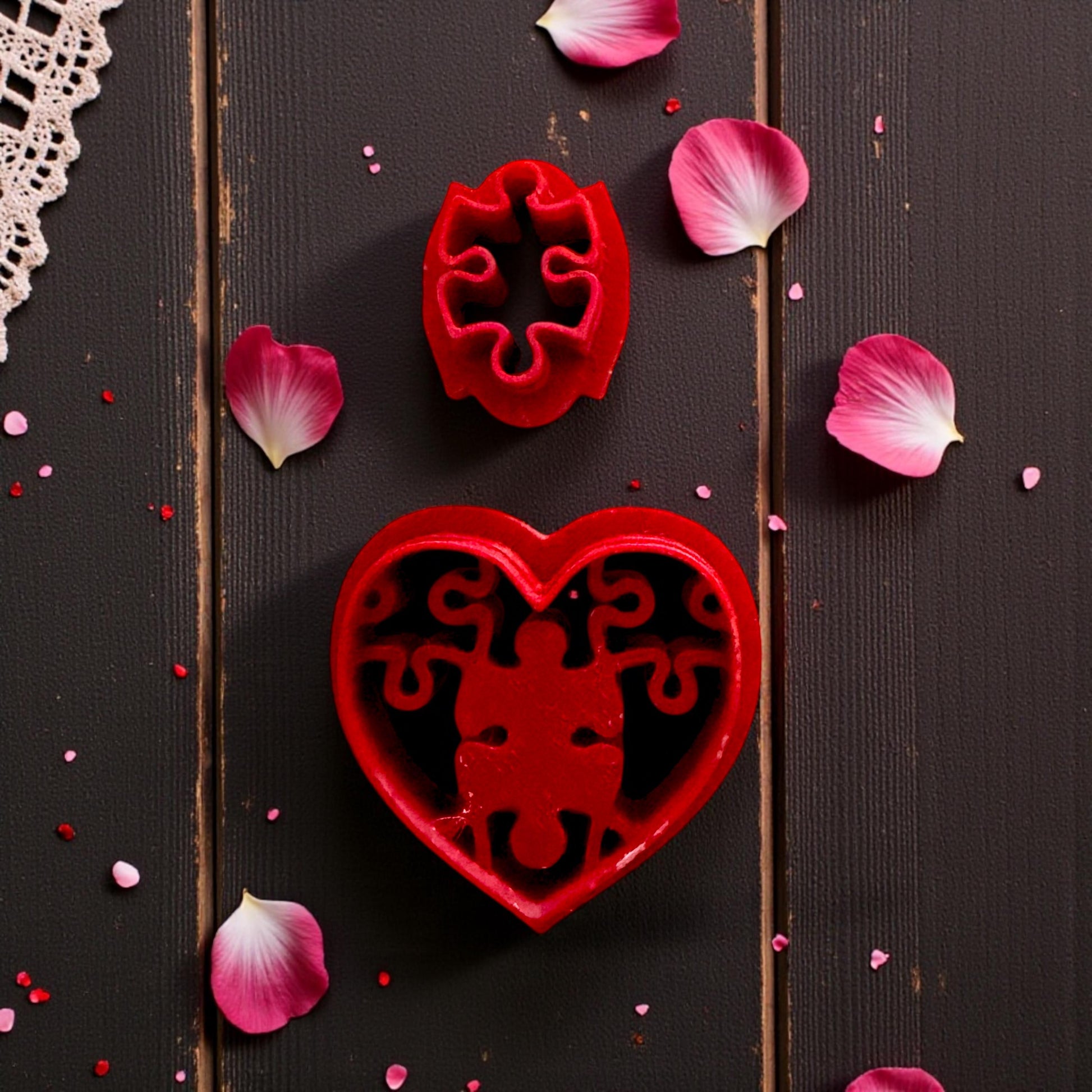 close up of red cutter with puzzle heart stamp on lace