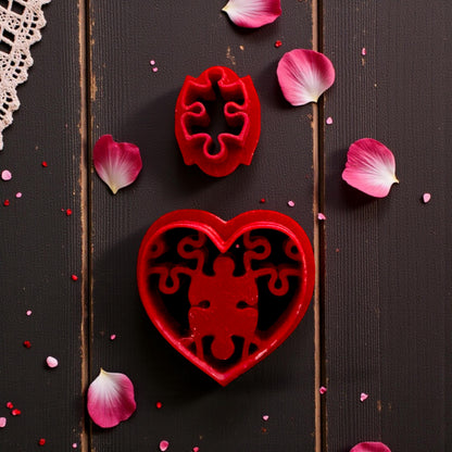 close up of red cutter with puzzle heart stamp on lace