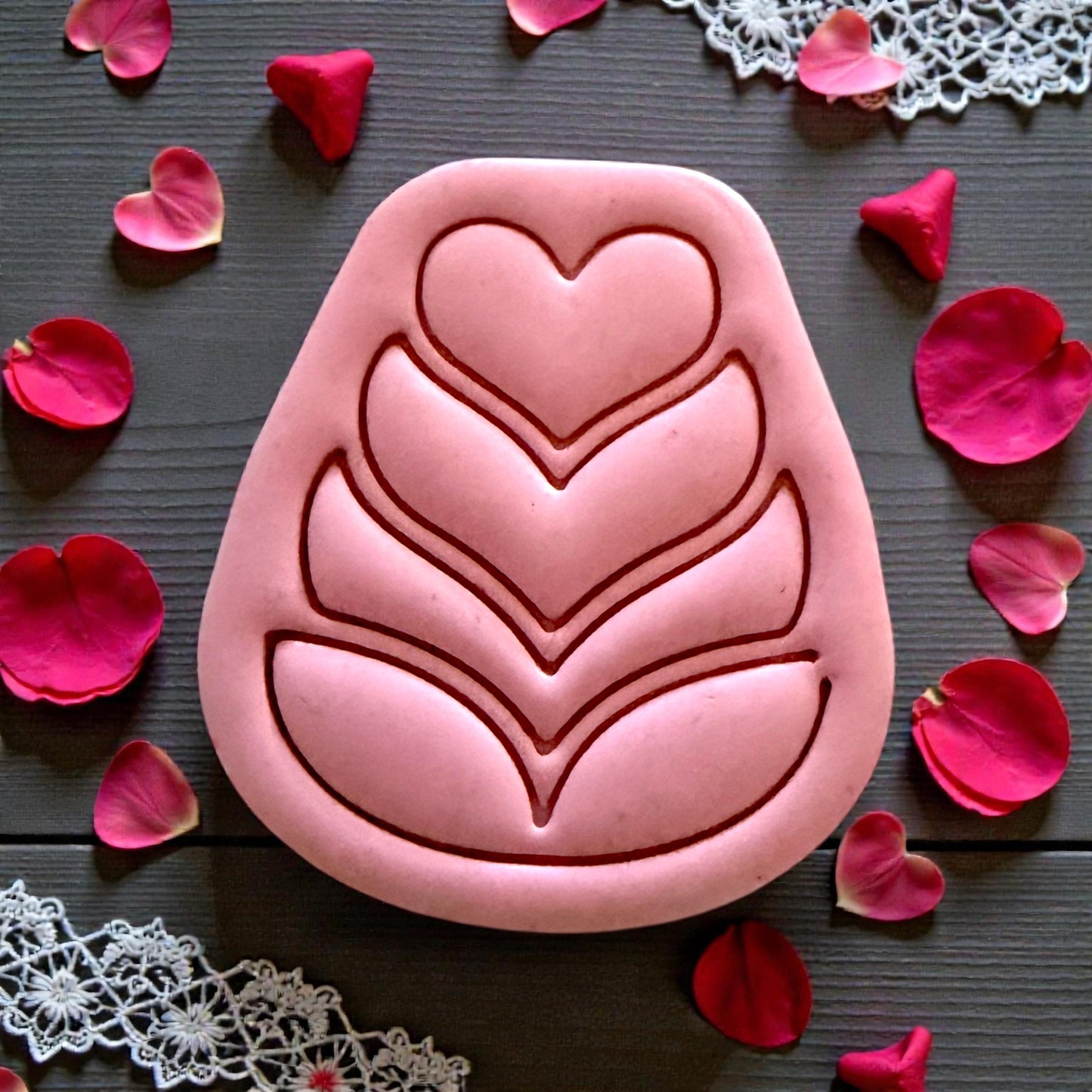 close up pink heart petal folk flower clay piece
