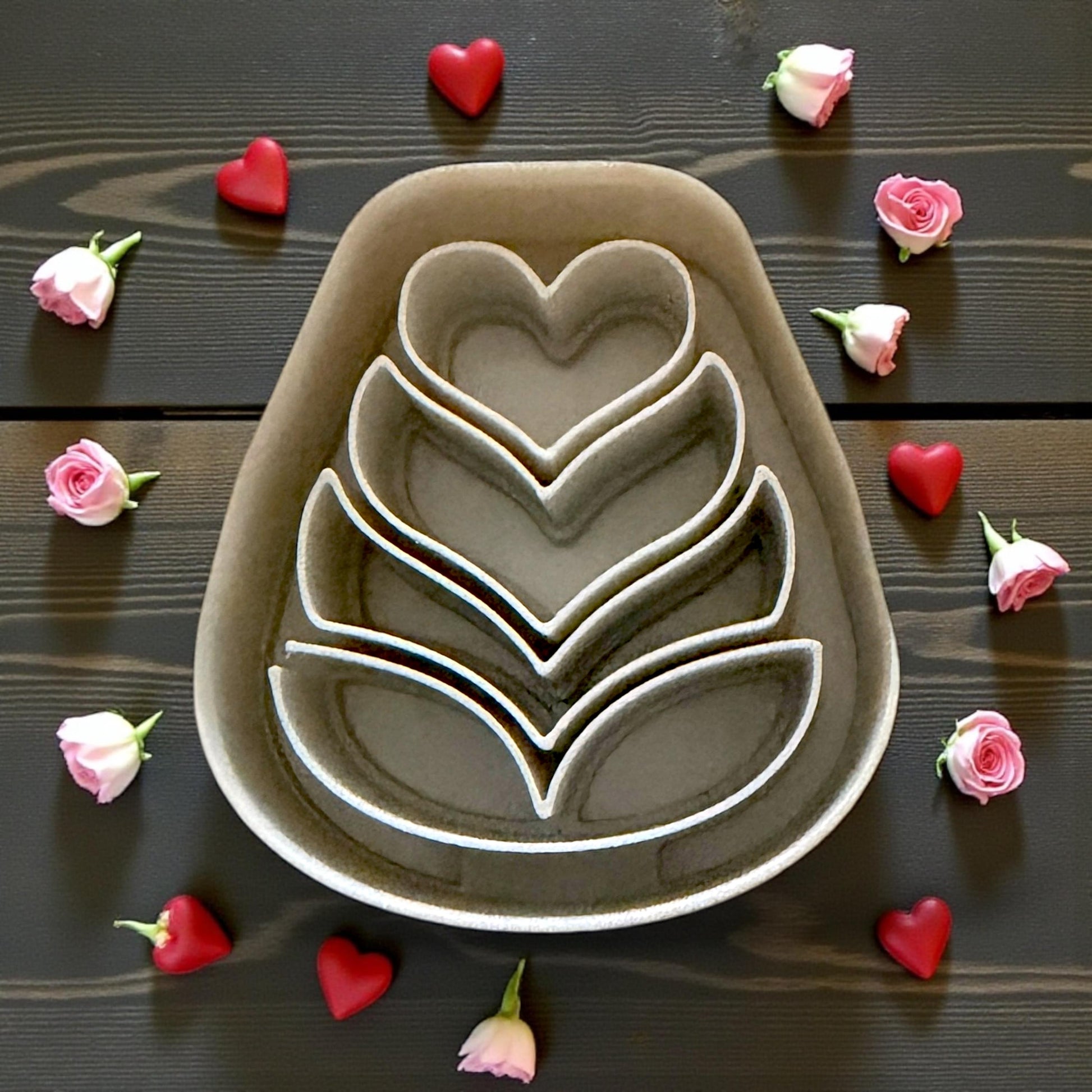 large gray folk heart flower cutter surrounded by roses