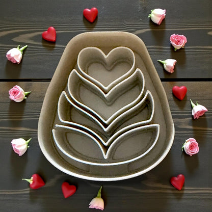 large gray folk heart flower cutter surrounded by roses