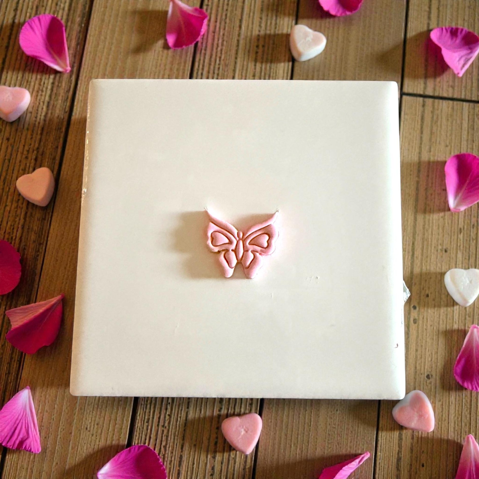 butterfly imprint centered on tile with petals