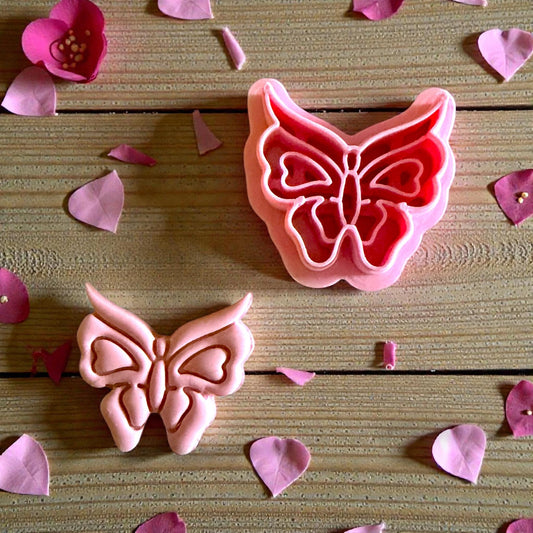 close up of butterfly imprint with cutter beside it