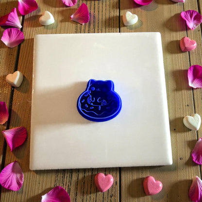 blue kitty doughnut cutter centered on tile