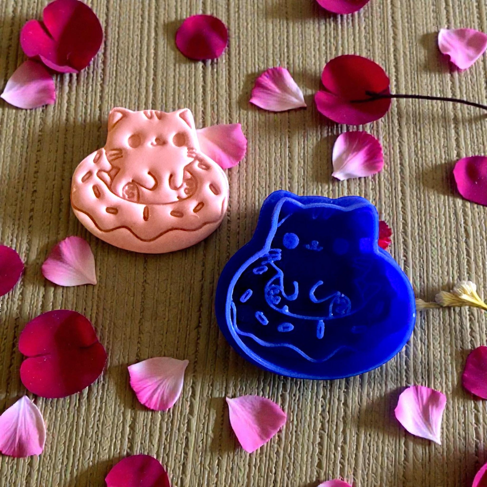 kitty doughnut clay and blue cutter on textured surface