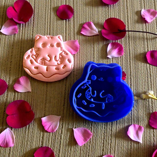kitty doughnut clay and blue cutter on textured surface