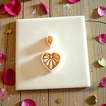 heart floral clay cutters on white tile with pink petwo piece heart floral clay cutter set on wood backgroundtals
