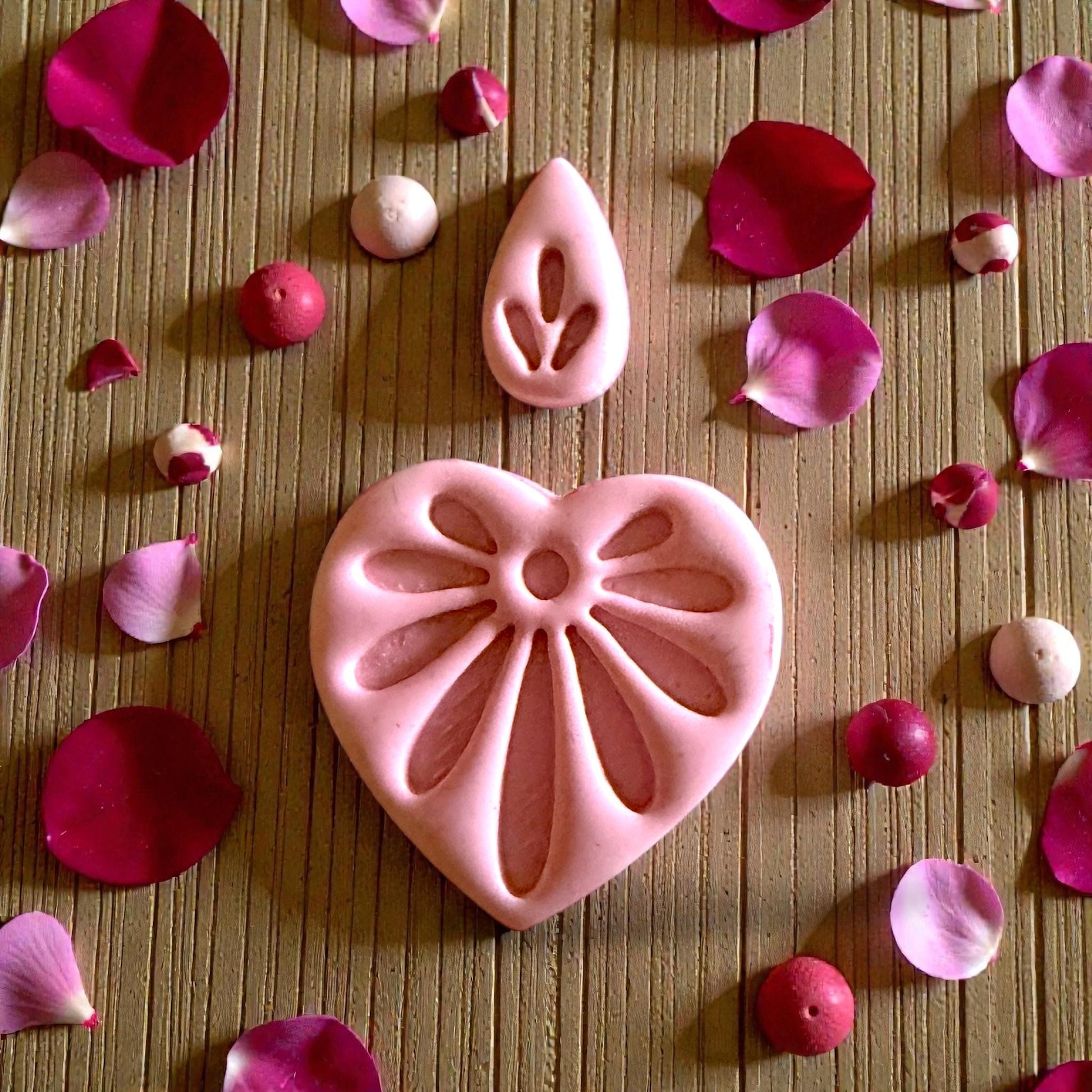 close up heart floral clay imprint with petals and flame