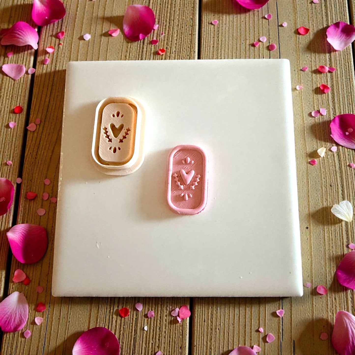 heart plaque and cutter displayed on tile with petals