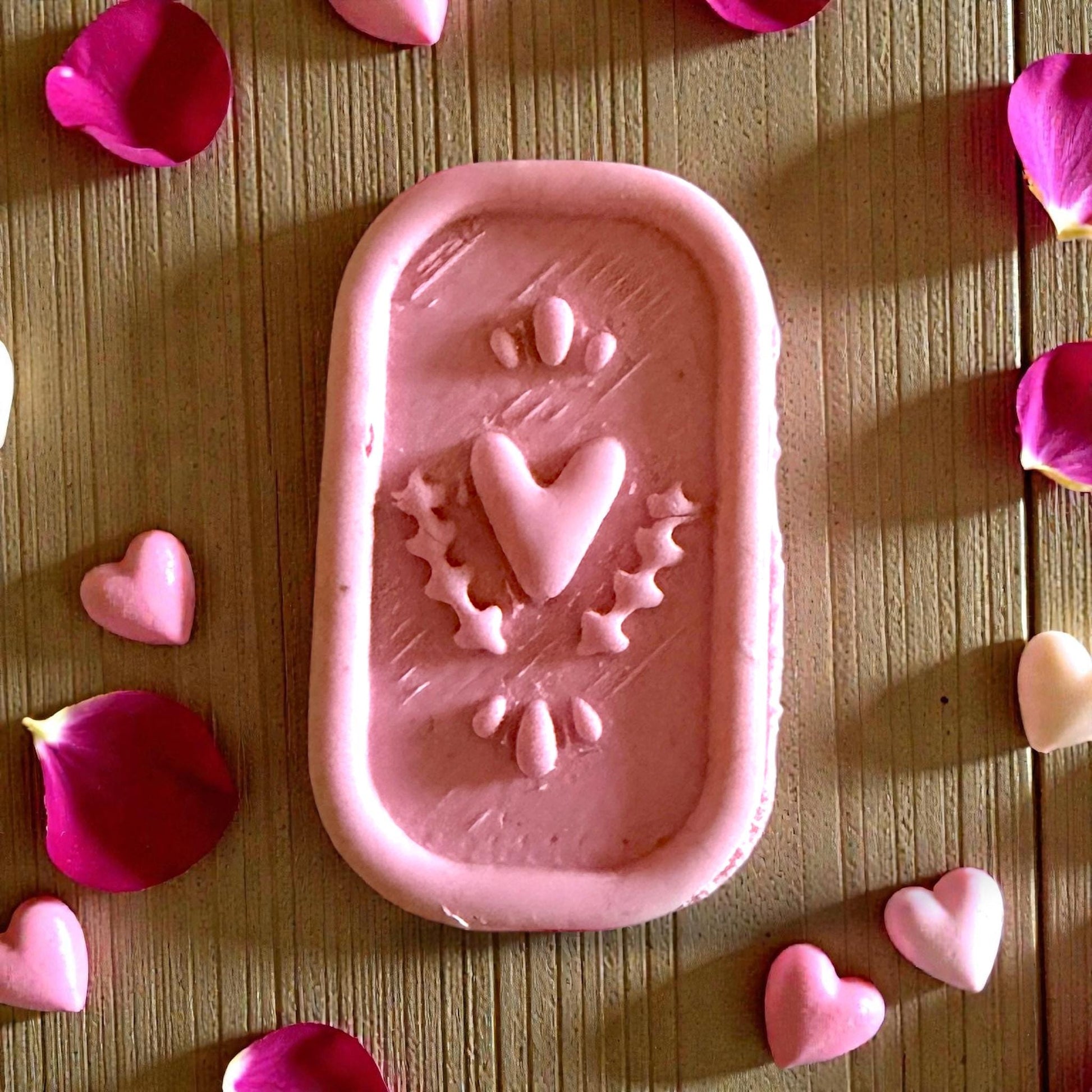 closeup of heart plaque cutter imprint with petal cutouts