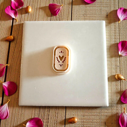 tan cutter on white tile with scattered petals