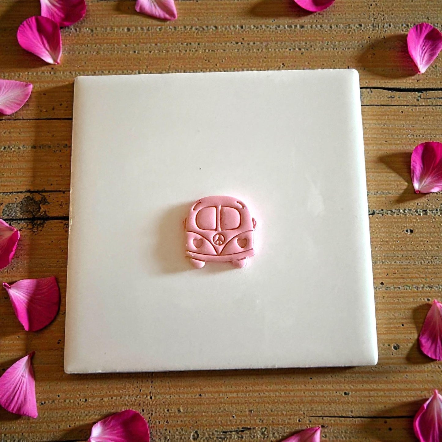 small love bus clay impression on white tile