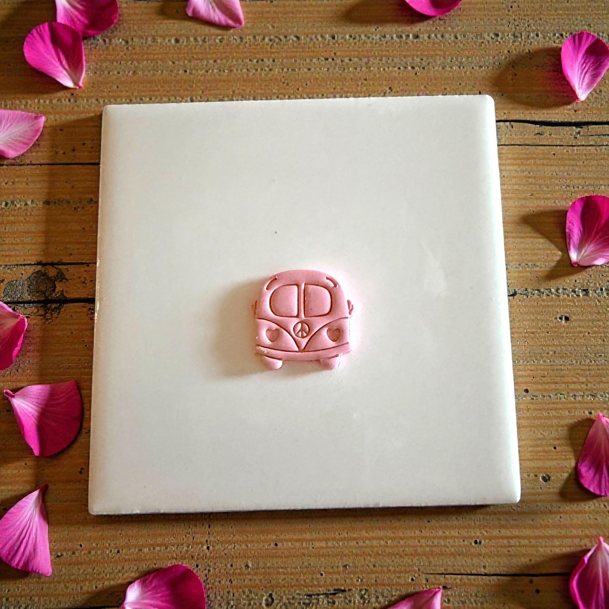 small love bus clay impression on white tile