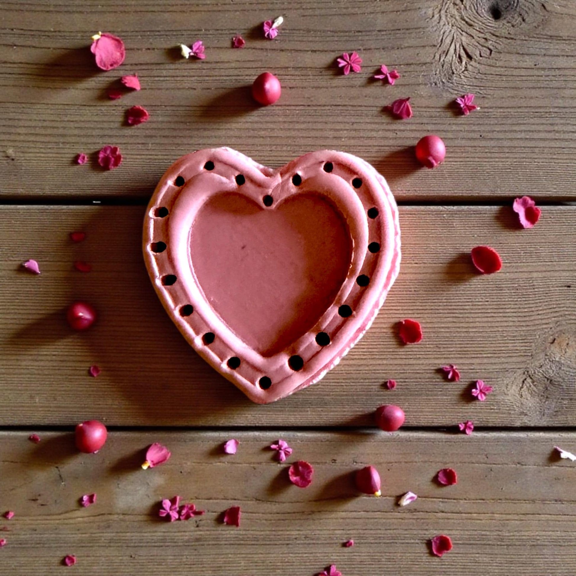 large pink dotted heart clay piece with border dots