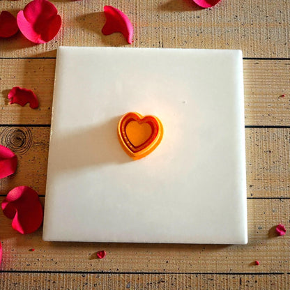 orange dotted heart cutter displayed on tile