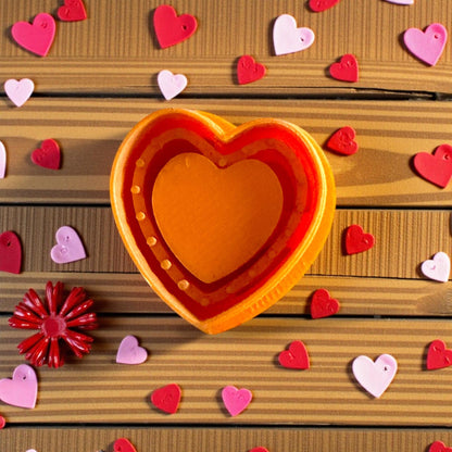 orange heart clay cutter surrounded by pink confetti