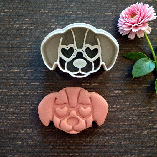 puppy cutter next to clay impression on dark wood