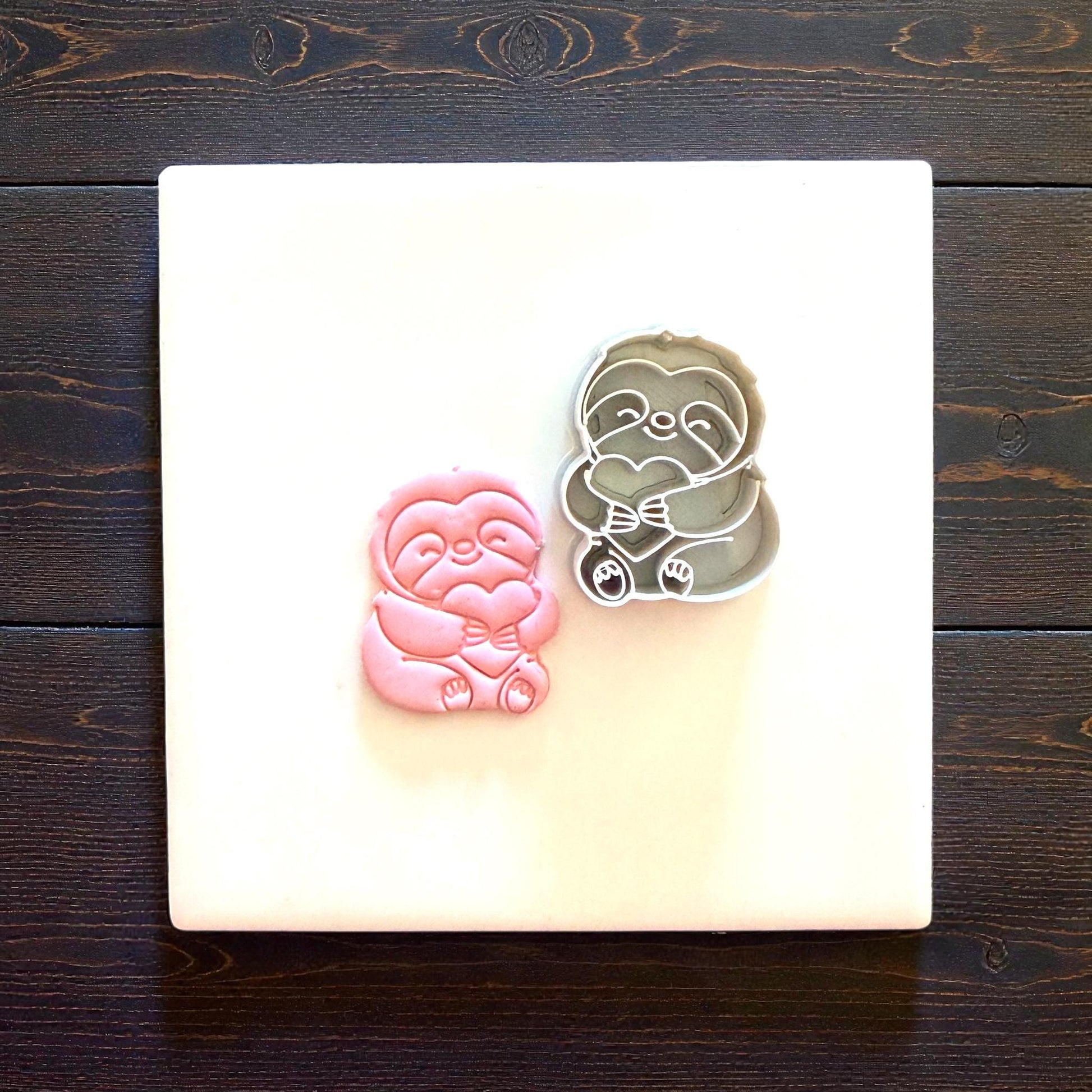sloth imprint and cutter on white tile