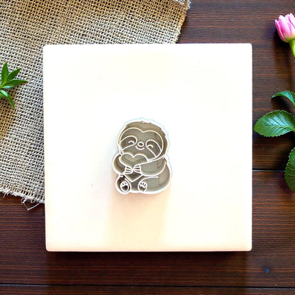 sloth clay cutter close up with floral accent
