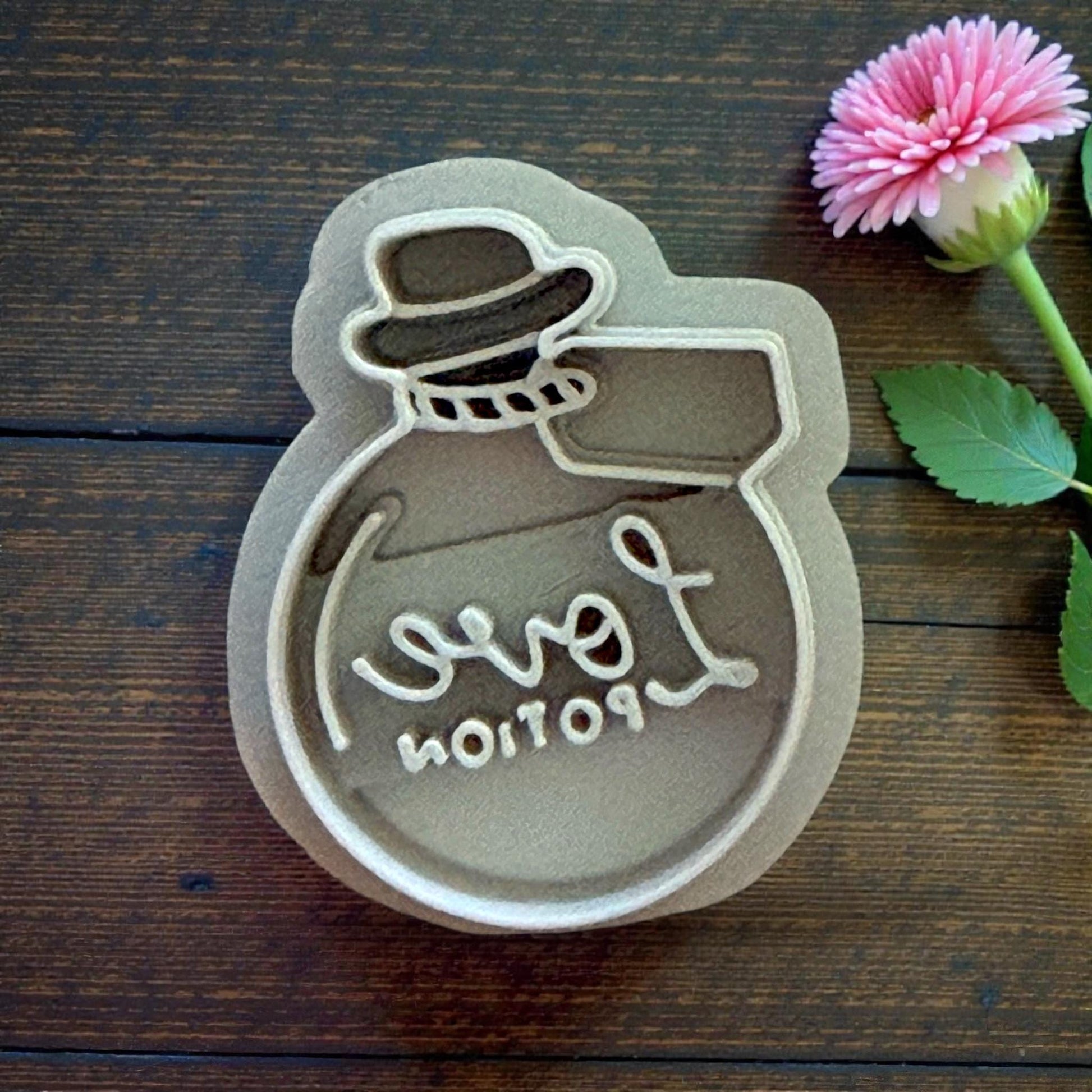 closeup love potion clay cutter with leaf decor