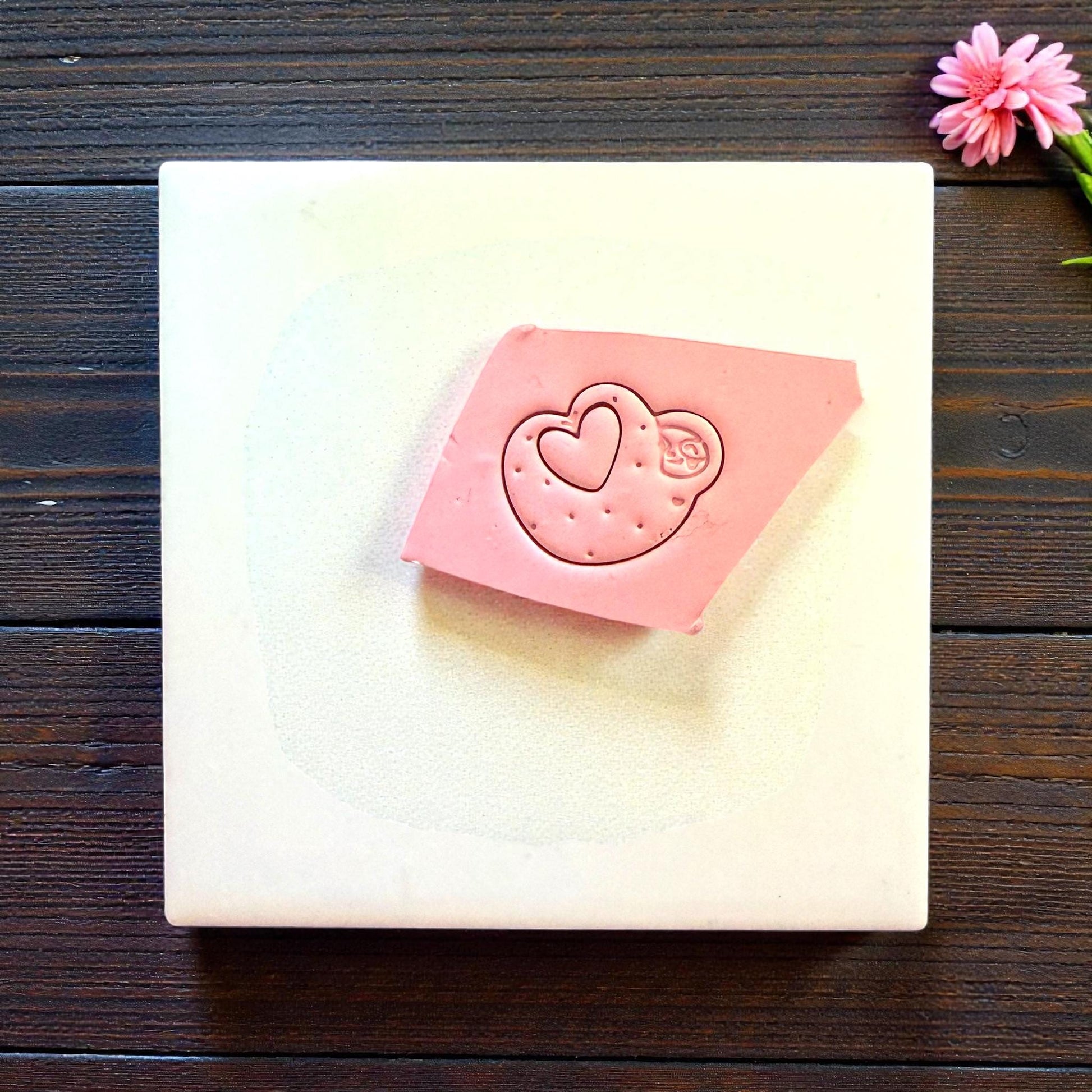 Pink clay slab with sloth heart cutter impression