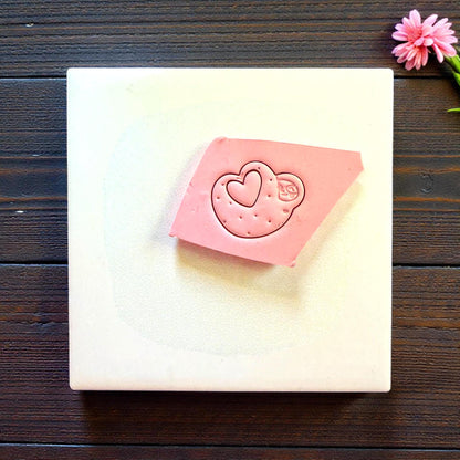 Pink clay slab with sloth heart cutter impression