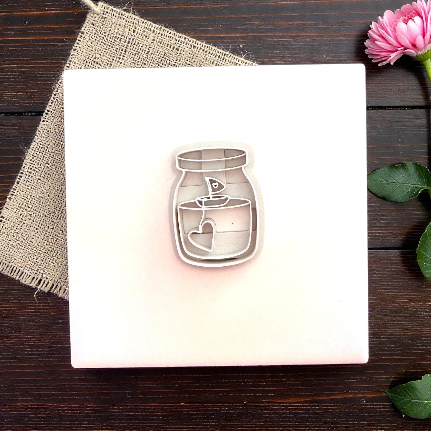 Candle jar polymer clay cutter centered on white tile