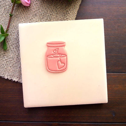 Small candle jar clay impression centered on white tile