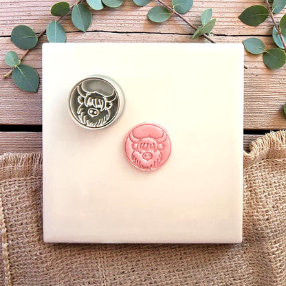 clay cutter and cow stamp side by side