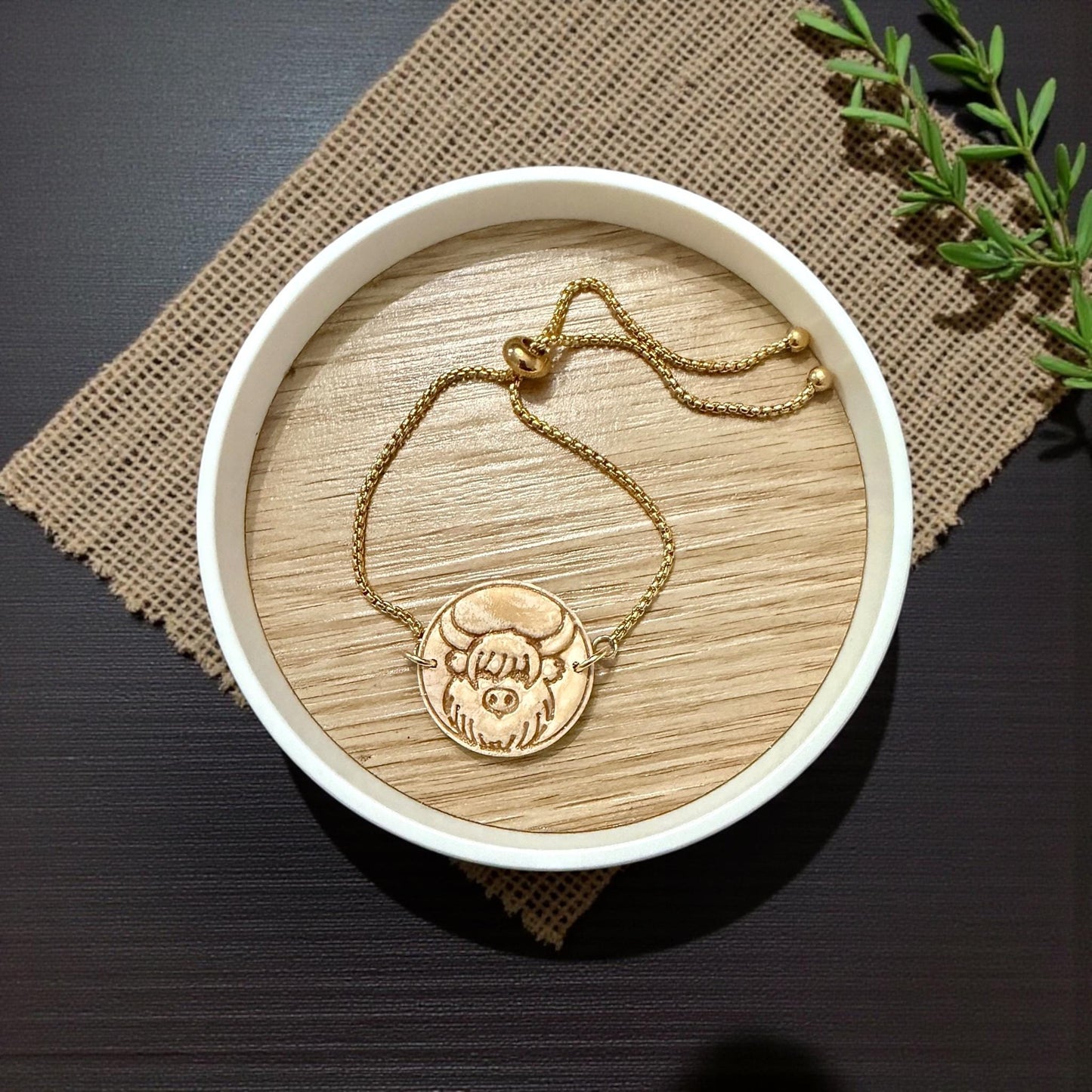 gold bracelet with highland cow charm