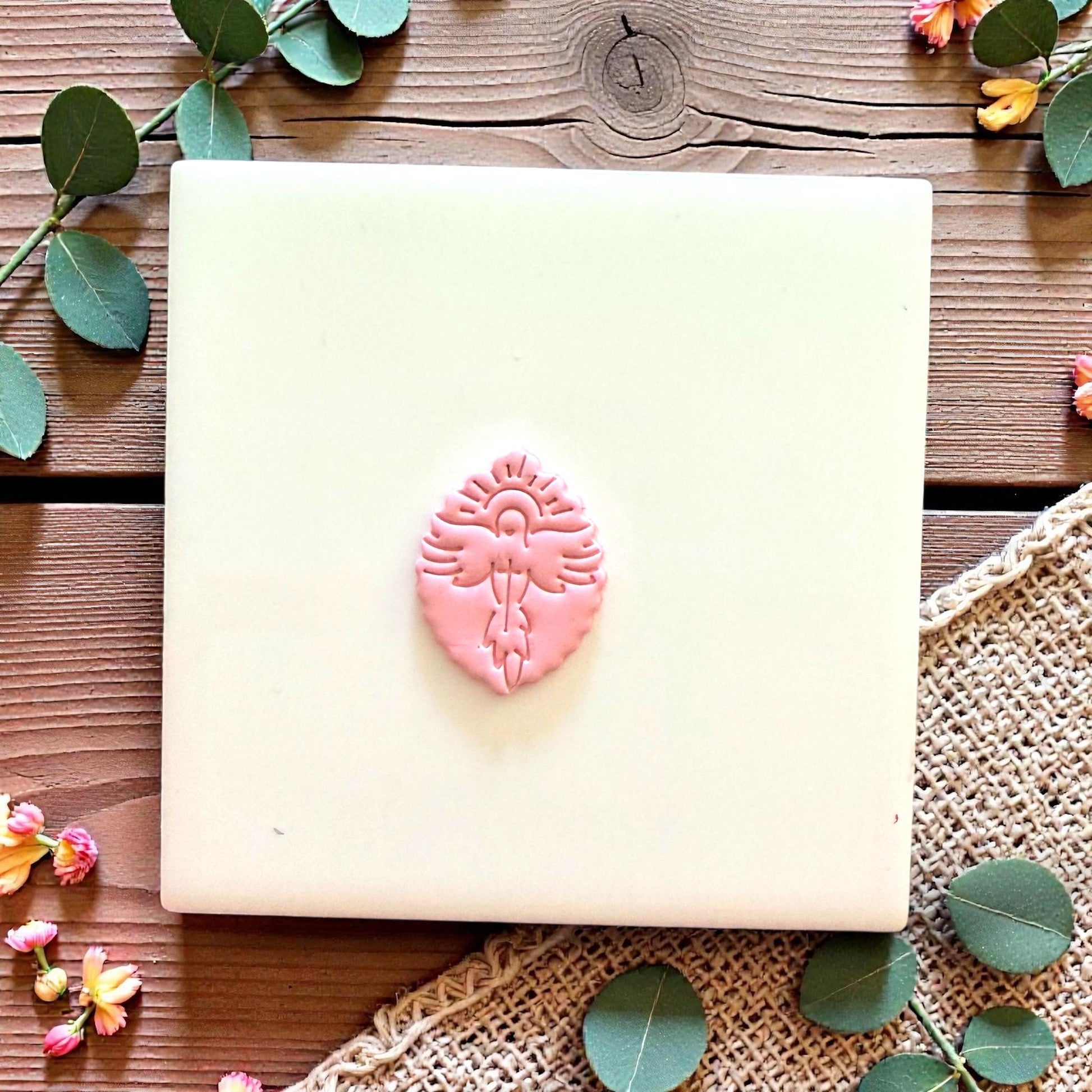 Close up of dove clay cutter with halo and cross design