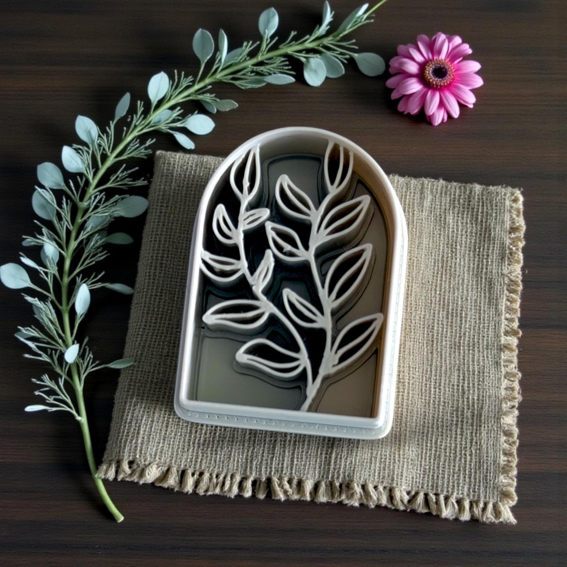 botanical arch cutter close-up with greenery