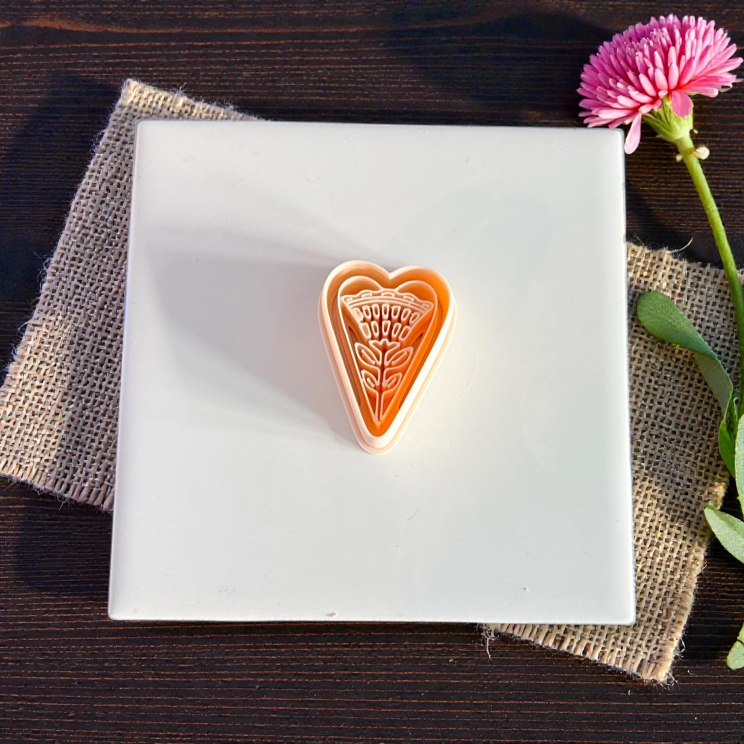 folk heart floral cutter on white tile with pink flower