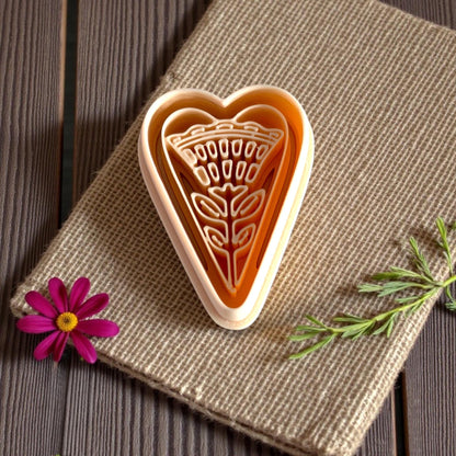 folk heart floral cutter set in warm lighting with flower