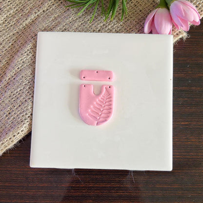 Finished pink clay fern U-shape and bar piece on tile