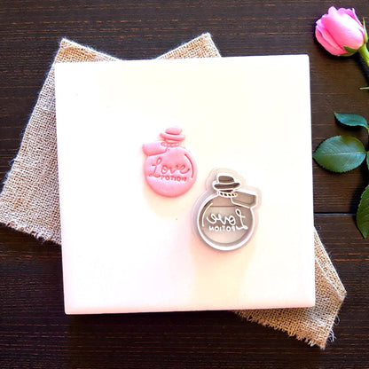 clay cutter and clay love potion on white tile