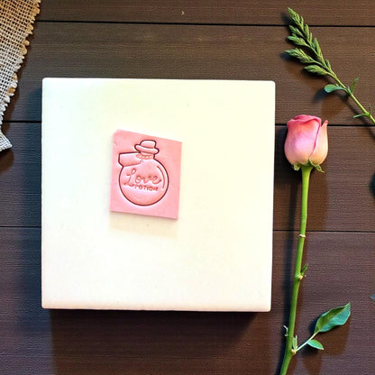 love potion clay imprint on white tile with rose