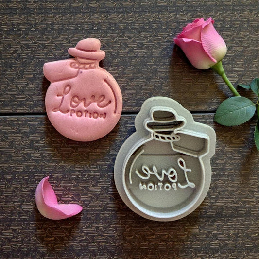 love potion cutter and pink clay piece side by side