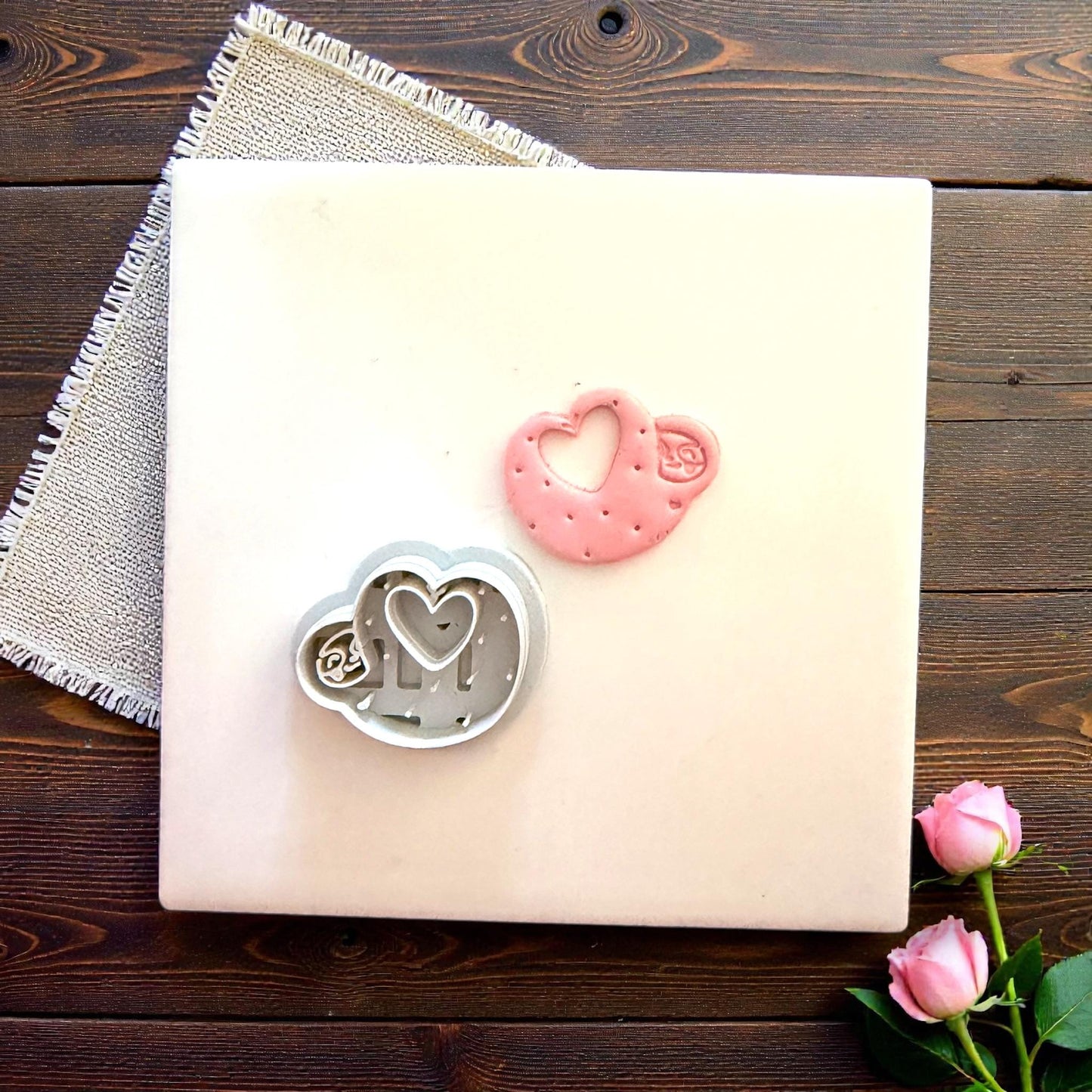 Cutter and clay sloth heart displayed together on tile