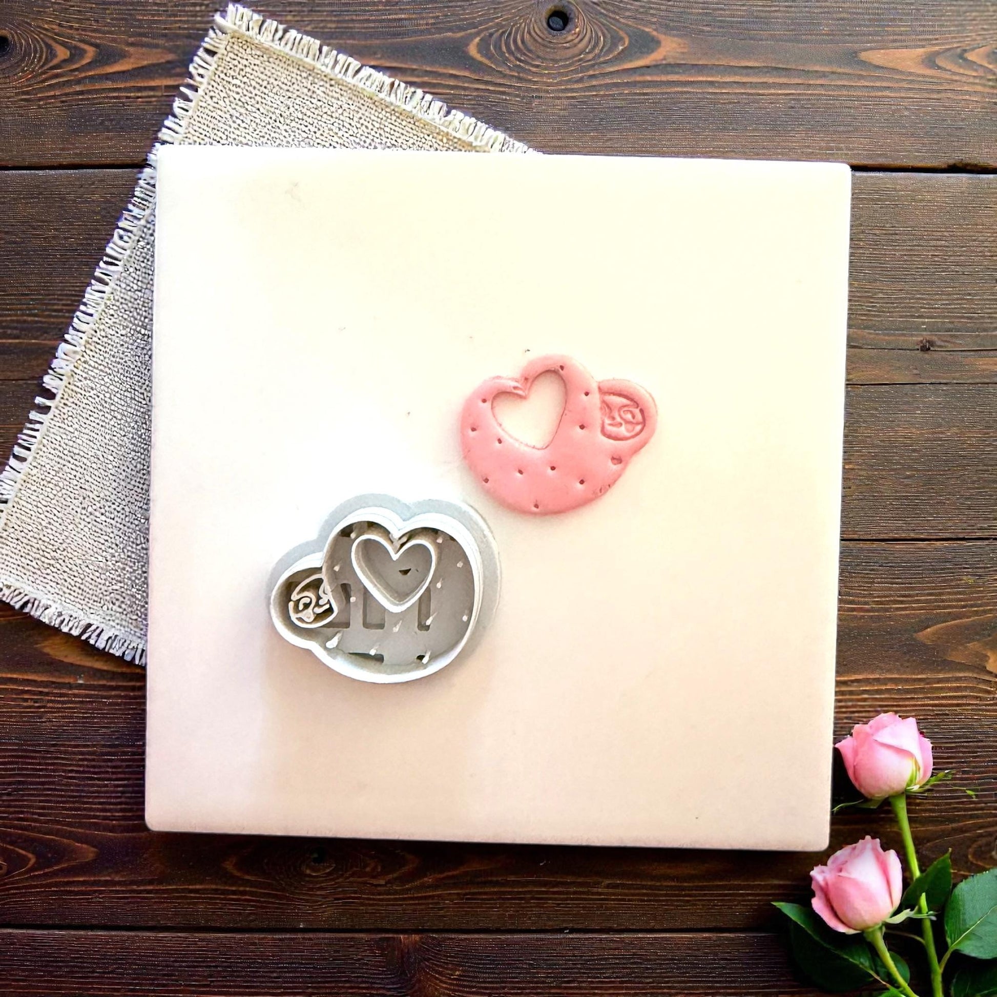 Cutter and clay sloth heart displayed together on tile