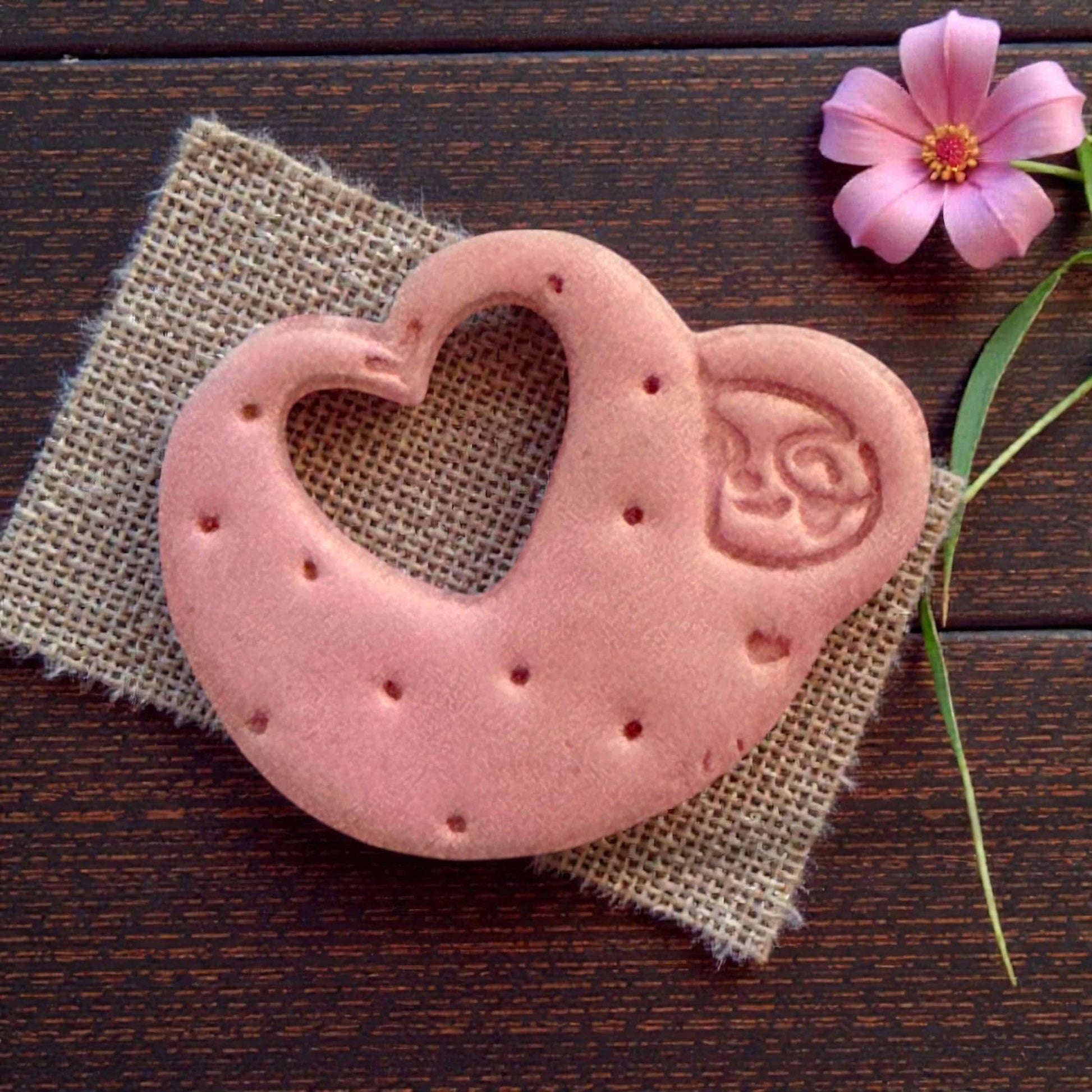 Open-heart sloth clay shape on burlap