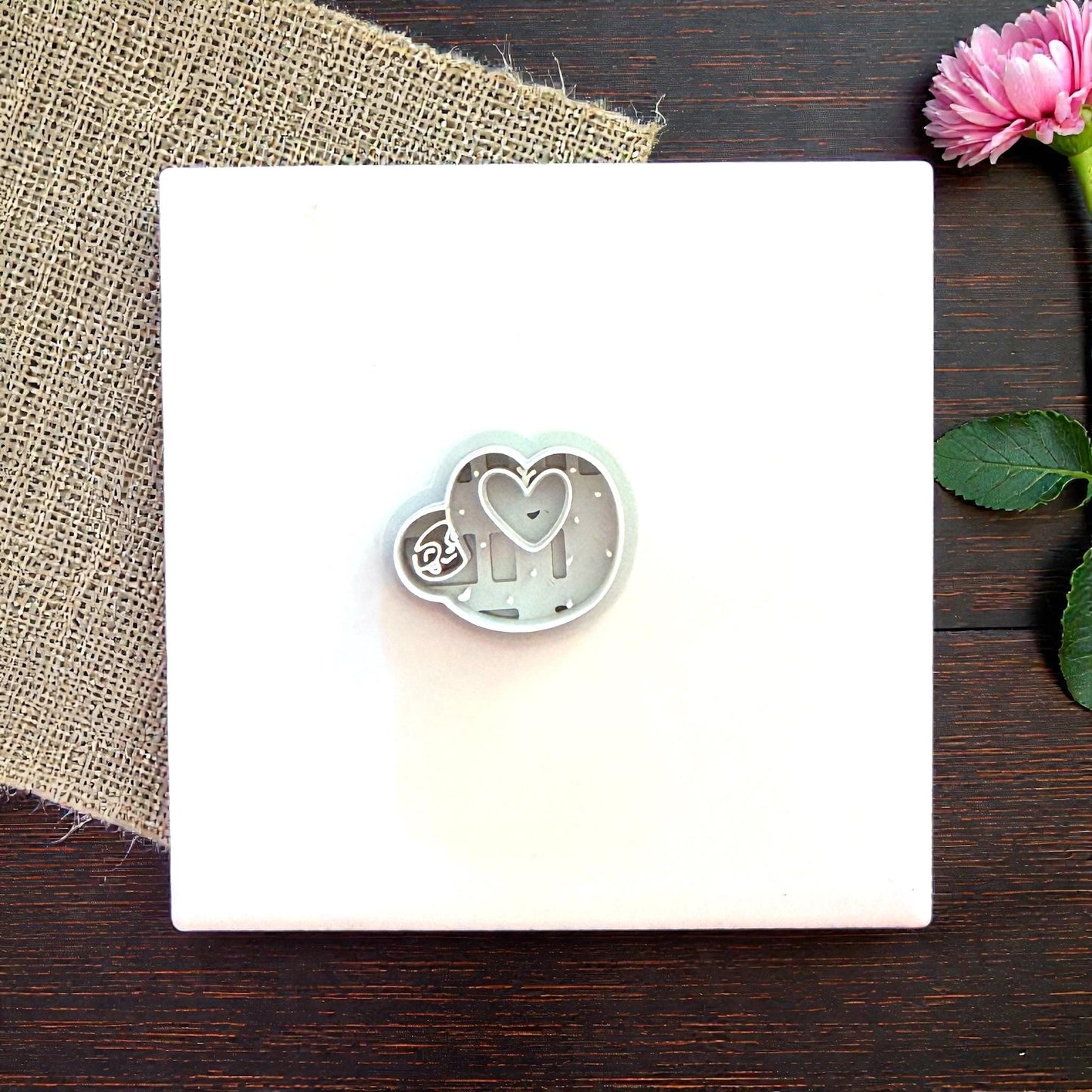 Sloth heart cutter on white tile with flowers