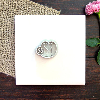 Sloth heart cutter on white tile with flowers