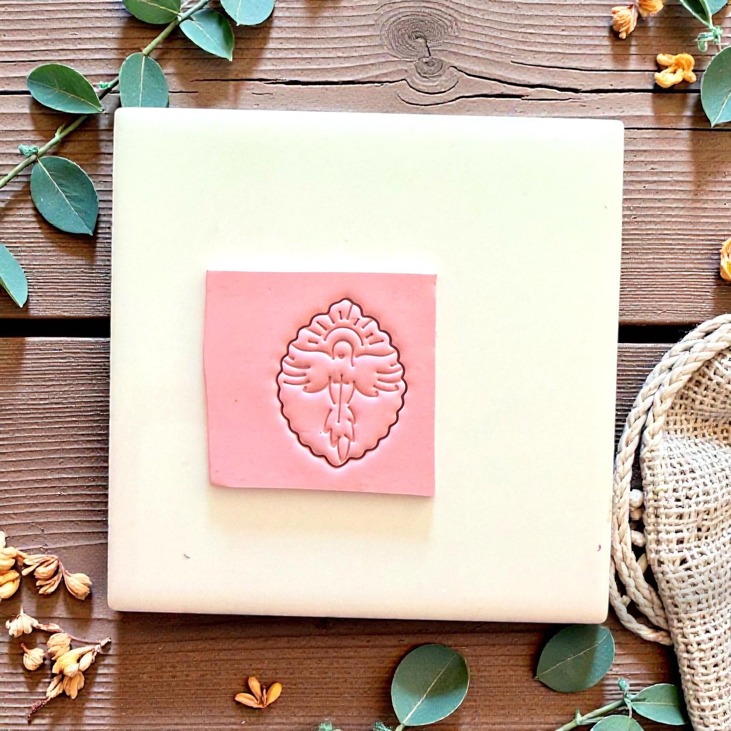 Dove polymer clay cutter with cross on white tile